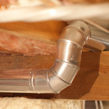 a close up of a metal pipe on a piece of wood