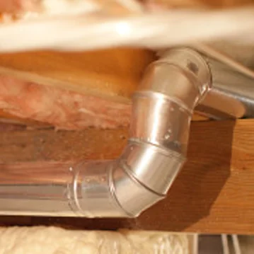 a close up of a metal pipe on a piece of wood